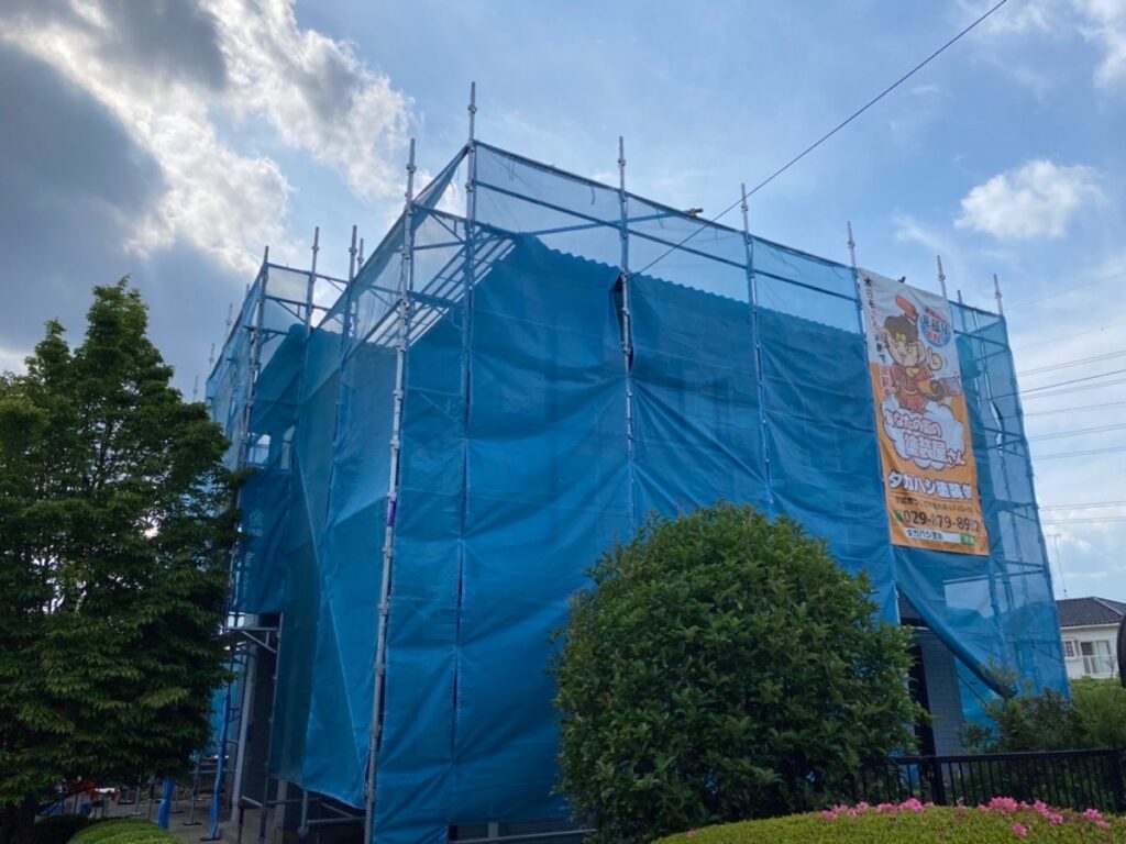 足場組立<br />
（塗料が飛散しないようにメッシュシートもしっかりとはります。）