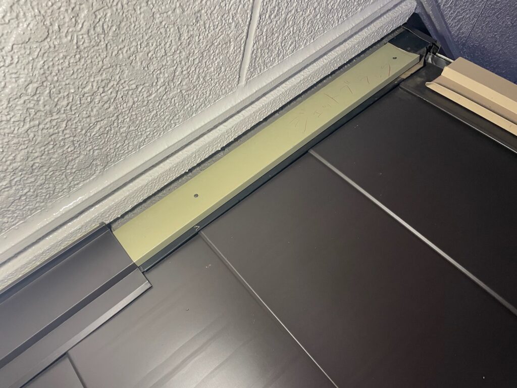 雨押さえ施工<br />
（雨押さえは雨漏れがしやすい箇所の為、雨仕舞をしっかりと行いました。<br />
※屋根の下に板金を入れ、雨が中に入らないようにしています。）